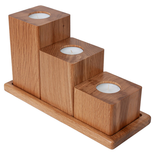 Wooden candle holder with three cylindrical candle holders on a white background