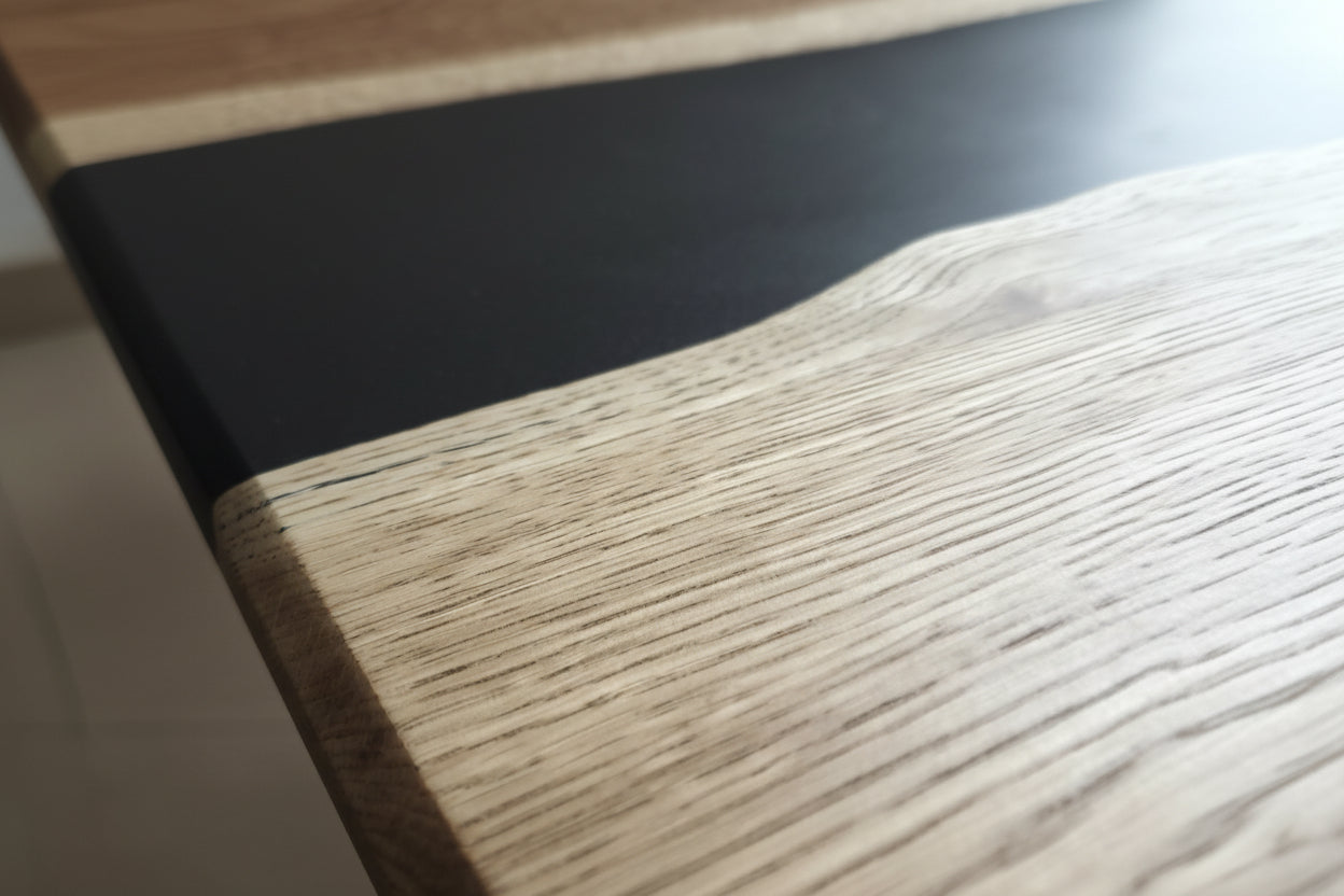 STRØM river coffee table with dark epoxy resin and live edge oak on black steel legs closerup