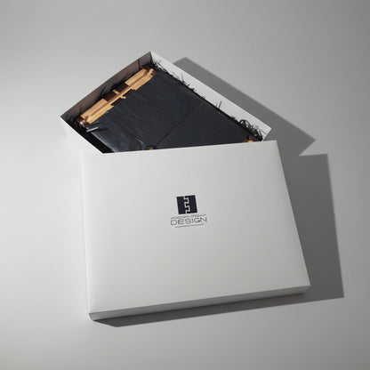 Cutting board In a White box with a logo