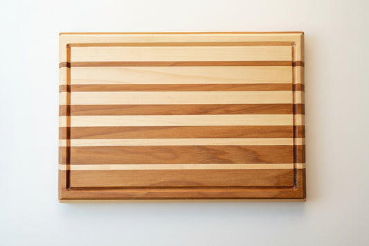 Wooden cutting board with striped pattern on a white background