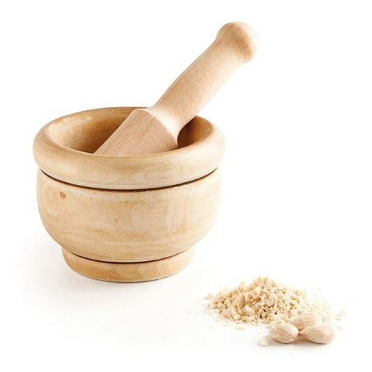 Wooden mortar and pestle with a small pile of crushed garlic on a white background
