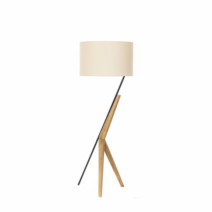 Floor lamp with a white shade and wooden legs on a white background