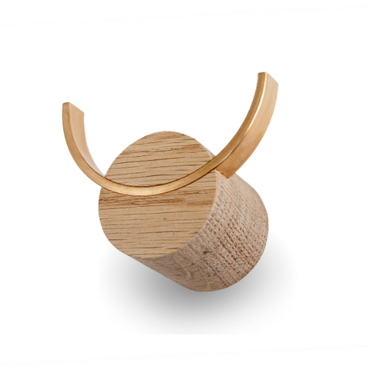 Oak wood wall hook with a brass hook, a unique design on a white background